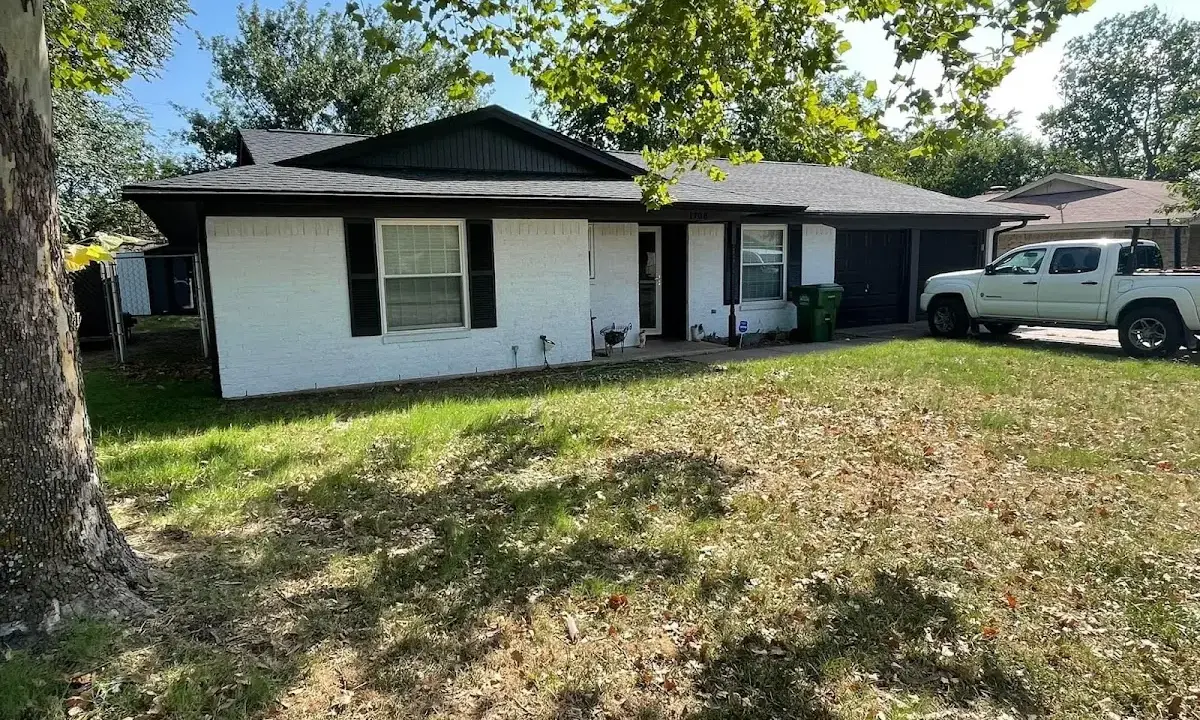 Professional roofing crew working on a residential roof in Kewanee